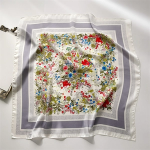 Detailed pattern of a French floral silk square scarf with colorful flowers on a white base