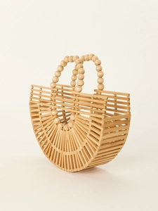 Macro detail of natural bamboo weaving with beaded handle on a semi-circular beach bag
