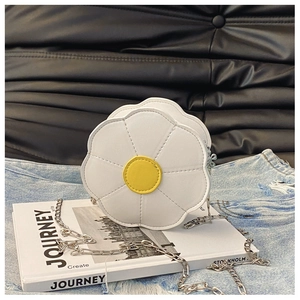 Close-up of white sunflower-shaped kids shoulder bag with gold center and metal chain