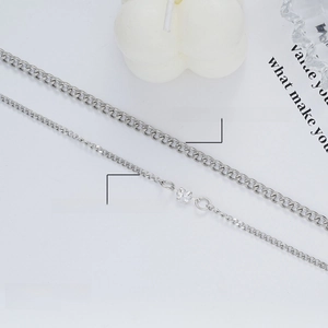 Silver-colored heart bracelet set with crystal pendant on a minimalist grey background