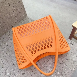 Detail of orange hollow jelly bag with mesh structure and removable inner pouch
