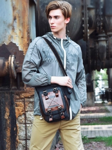 Men's canvas messenger bag in black and brown featuring multi-pocket flap design