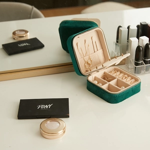 Dark green velvet jewelry box with multi-functional interior compartments and mirror