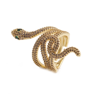 Close-up of gold snake ring with white cubic zirconia pavé and green gem eyes