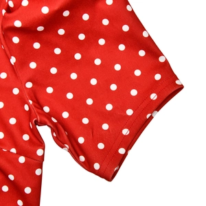 Detailed close-up of the short sleeve and seam on a red vintage polka dot dress