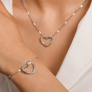 Minimalist silver stainless steel hollow heart necklace and bracelet jewelry set on model