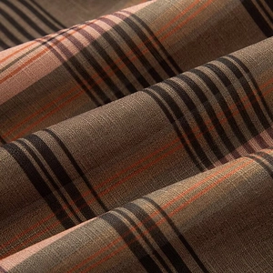 Detailed macro view of brown and beige plaid cotton linen fabric texture and weave