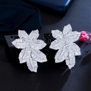 Exquisite leaf-shaped drop earrings with micro-paved zircons on a dark display