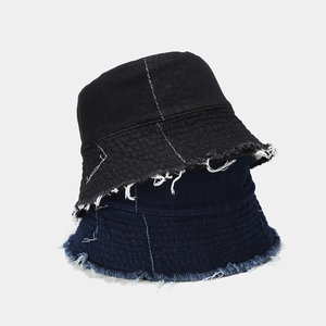 Irregular patchwork denim bucket hat with frayed edges in black and dark blue