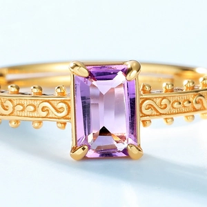 Macro shot of S925 silver ring with rectangular purple amethyst and vintage gold engraving