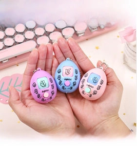 Close-up of rock-paper-scissors game keychain featuring LCD screen and egg-shaped design