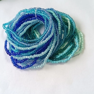 Macro shot of multi-layer blue and green gradient glass seed bead stretch bracelets