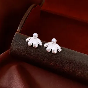 French vintage style silver petal earrings with white pearls on a leather box