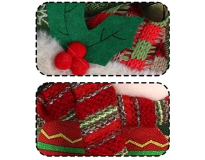 Detail of red and green knitted Christmas stocking with felt leaves and tiny metal bell