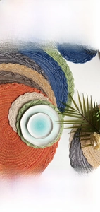 Macro view of woven round placemats in multiple colors with spiral textures