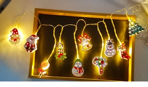 Festive Christmas LED string lights with warm glowing Santa and Snowman iron ornaments