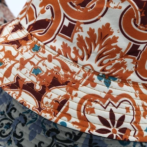 Macro detail of floral bucket hat showing durable cotton fabric and fine brim stitching