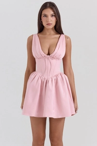 Detail of pink corset dress featuring deep V-neck with tie and structured waistline