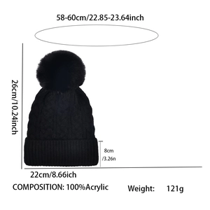 Black cable knit beanie with pom pom showing detailed size measurements and 100% acrylic material