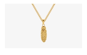 Macro detail of 18K gold-plated oval necklace pendant with queen portrait engraving