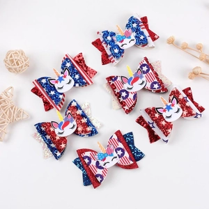 Detail of 6 glittery unicorn hair bows with patriotic stars and stripes patterns