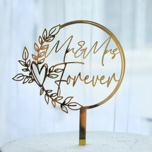 Golden acrylic Mr & Mrs wedding cake topper with elegant leaves and heart design