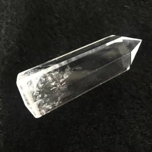 Macro shot of natural white crystal prism with unique ice cracks on dark texture