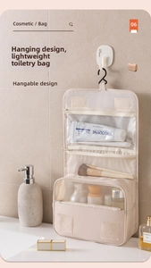 Detail view of hanging toiletry bag showing internal mesh pockets and transparent compartments