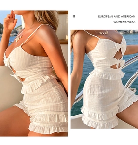 Close-up of white summer two-piece set featuring bow cutouts and ruffled hem details