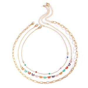 Three-layer gold necklace set featuring colorful butterfly charms and beaded chain detail