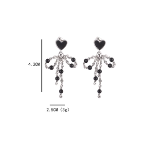 Silver bow dangle earrings with black heart studs and rhinestone tassel details
