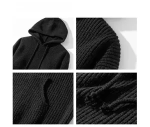 Detailed macro view of black chunky knit hoodie fabric texture and kangaroo pocket