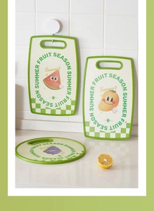 Detail of creative fruit-themed plastic cutting boards with non-slip handles for kids