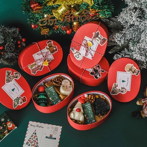 Christmas gift box featuring handmade snowman and tree candles on festive green background