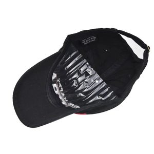 Detail view of 100% cotton baseball cap interior with wash label and black sweatband