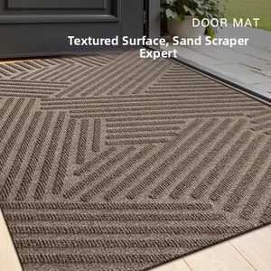 Detail of a brown non-slip PVC door mat with textured geometric pattern for scraping sand