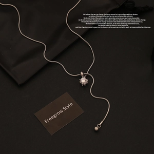 Detail of silver snake chain with cubic zircon pendant and adjustable bead slider
