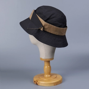 Women's two-tone washed cotton bucket hat with a stylish brown ribbon bow and sun protection