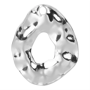 Macro shot of silver hammer-textured irregular circle pendant with a hollow center