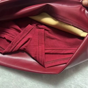 Detail view of burgundy PU leather mini skirt with built-in matching safety shorts
