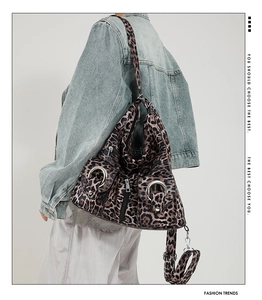 Detailed back view of leopard print hobo bag with silver rings on a model