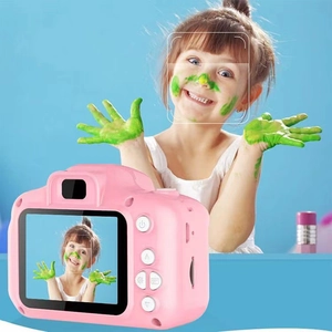 Pink kids digital camera featuring a clear LCD screen showing a smiling child photo