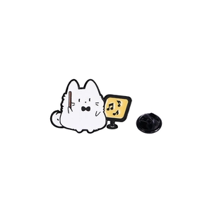 Close-up of a cartoon cat enamel pin conducting music with a yellow music stand