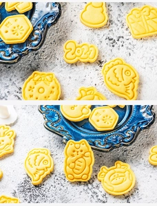 Detailed view of DIY Christmas cookie cutters shapes on a blue plate and stone table