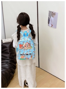 Rear view of child wearing light blue Capybara printed backpack in a minimalist room