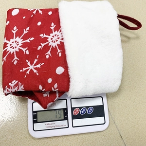 Macro detail of a large red Christmas stocking with snowflake patterns on a scale weighing 79g
