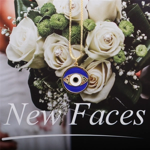 Detail shot of Turkish evil eye pendant with colorful zircons on a gold chain