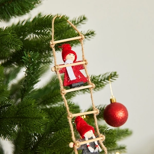 Christmas tree hanging ornaments featuring Santa figures climbing a rope ladder
