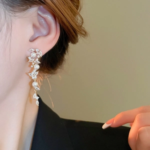 On-ear view of long tassel earrings with marquise rhinestones and elegant pearls