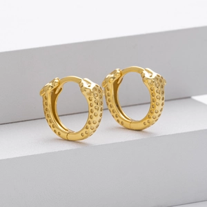 Detailed close-up of golden leopard head hoop earrings featuring textured animal patterns